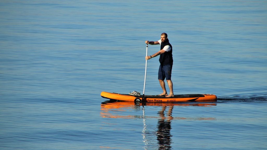 Man paddleboarding on the ocean